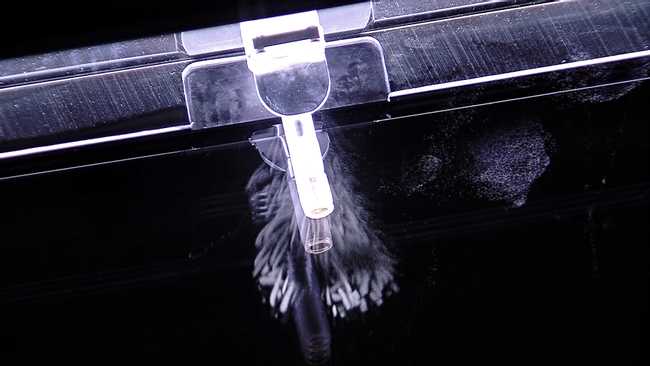 Artificial nuclide americium-241 emitting alpha particles inserted into a cloud chamber for visualisation Artificial nuclide americium-241 emitting alpha particles